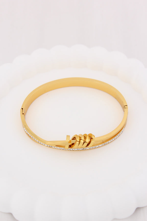 Gold Stainless Steel Bangle With A Twist And Rings (BA032)