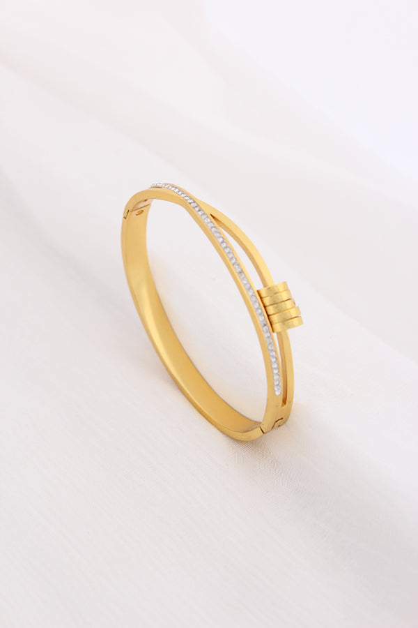Gold Stainless Steel Bangle With A Twist And Rings (BA032)